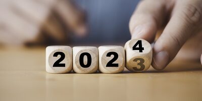 Hand rolling dice from the year 2023 to 2024.
